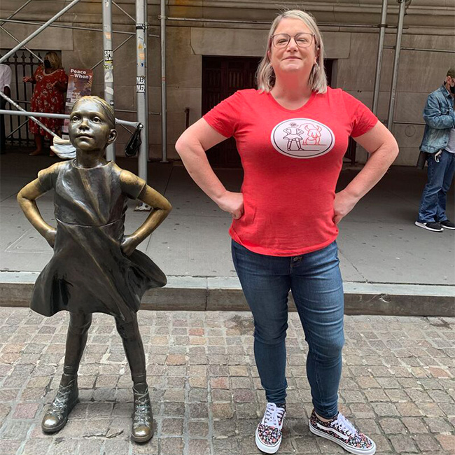 Woman wearing the iconic Fearless Girl T-shirt